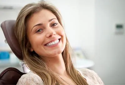 patient smiling after dental fillings helped preserve her smile