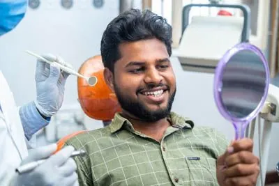 patient smiling after dental crowns helped restore his smile