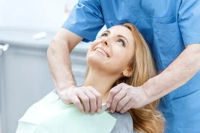 patient talking with her dentist about dental implants