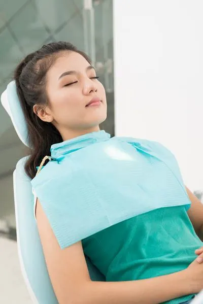 patient asleep during her oral surgery procedure thanks to sedation dentistry